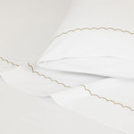 Dreamology luxury cotton sheet set unfolded to show the complete flat sheet, fitted sheet, and two pillowcases