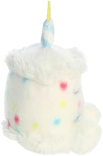 Pocket sized Aurora white birthday cake collectible plush resting in a hand.