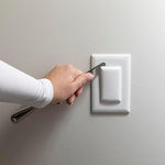 Minimalist white Qdos outlet cover on wall