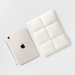 Comfyable minimalist Scandinavian style puffer tablet bag back view with elegant exterior tag