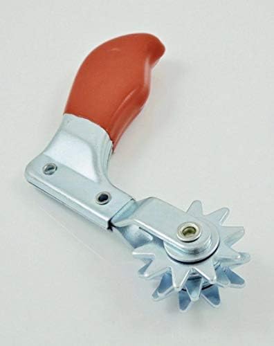 Close up view of the durable metal spur polishing pad cleaner removing compound residue from a wool buffer.