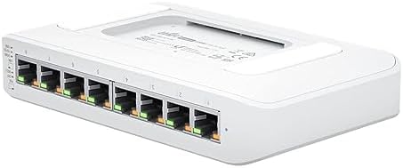 Ubiquiti Networks 8-port switch laid out with its external sixty-watt power adapter and power cable.