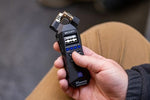 Compact black Zoom 32-bit float portable audio recorder displaying the side connectivity ports and premium structural build.