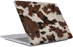 Generic cowhide pattern laptop protector top view on a wooden desk
