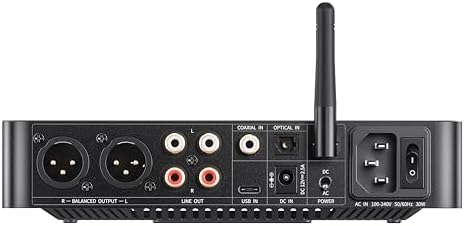 FiiO K13 premium black audiophile desktop DAC system sitting next to high end headphones