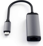 Satechi Ethernet adapter connected to a MacBook Pro showing premium metal finish