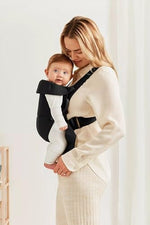 Adjustable buckle straps and head support details on BabyBjorn mini carrier
