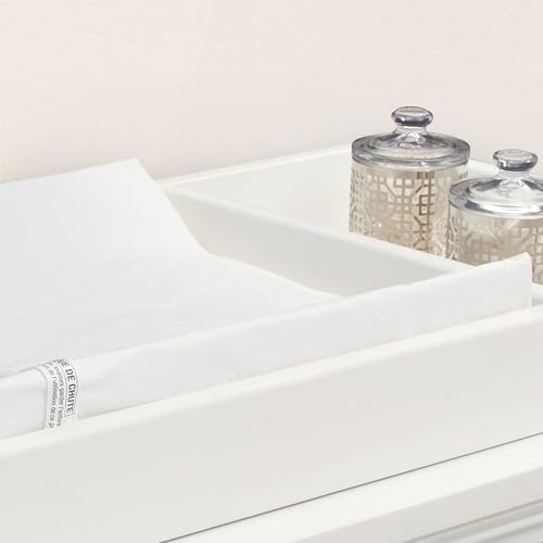 White Delta Children changing pad with contoured safety sides