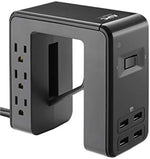 APC U-shaped surge protector clamped to a desk edge