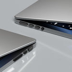 Side view of laptop with flexible anti dust plugs inserted into HDMI and headphone slots
