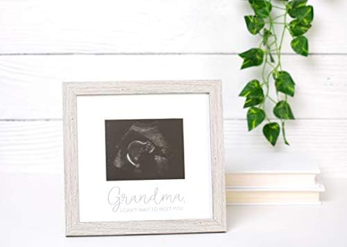 Kate & Milo pregnancy announcement baby keepsake frame displayed on a wooden living room table