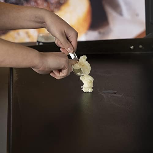 Applying premium Blackstone griddle conditioner on a warm iron cooktop