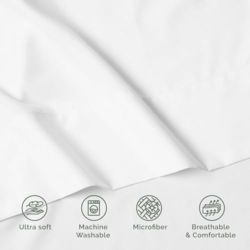 Crisp white imported luxury flat sheet styled in a modern bedroom setting.