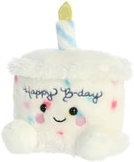 Aurora Palm Pals Happy Birthday Cake stuffed toy displayed as a bedroom decoration.