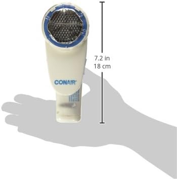 White Conair fabric defuzzer being used on a wool sweater to remove lint.