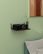 Top down view of mini projector mounted on wall shelf