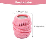 Three piece reusable fabric softener dispenser balls tumbling inside a washer drum