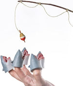 An adult and child finger demonstrating the comfortable fit of the mini novelty shark puppets