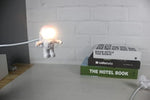 Close up view of the SOONDAR spaceman night light showing the helmet visor flipped open to emit light