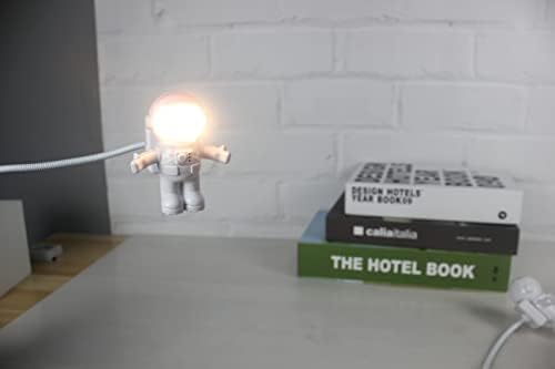 Close up view of the SOONDAR spaceman night light showing the helmet visor flipped open to emit light