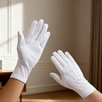 Pair of Coyaho white hosiery cotton gloves showing breathable texture.