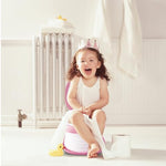 Toddler using Spark Moments travel potty outdoor