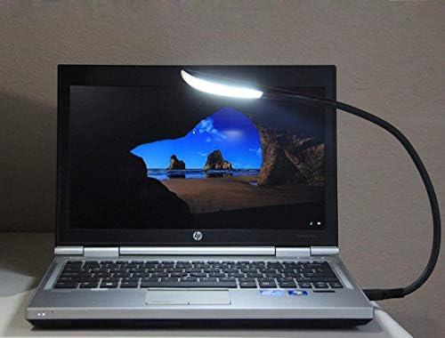 i2 Gear portable keyboard lamp plugged into a standard laptop computer port providing workspace illumination.
