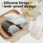 Two ounce white and grey squeezable silicone containers for toiletries