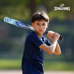 Kids using Spalding baseball gear in a backyard setting