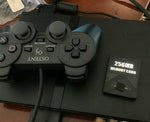 Official matching charcoal black wired controller showing responsive analog sticks and classic button layout