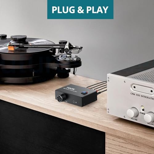 YGiTK phono preamplifier package contents including the compact black unit and the twelve volt power adapter.
