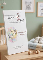 Heart's Sign wooden pregnancy milestone frame mounted elegantly on a children's bedroom wall.