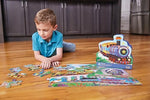 A child sorting the vibrant transport themed pieces of the Crocodile Creek 36 piece floor puzzle for early childhood skill development.