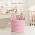 Pink toddler gift bucket with stitched rabbit ears resting on a nursery shelf
