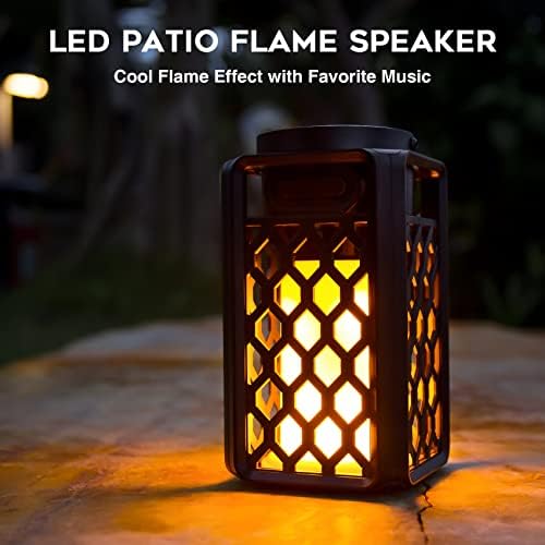 ANERIMST wireless audio lantern mounted as a landscape torch using included ground stakes in a lush garden pathway setting