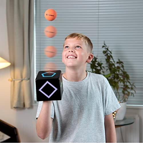 KOMBOID skill toy package contents showing the single tracking cube two yellow rubber balls and challenge cards