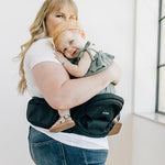 Authentic multi position compact hip seat carrier showing secure single buckle attachment.