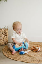 Close up of plush golf ball and tee sensory baby toy