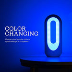 Enbrighten dimmable night light illuminating a home office desk in soft white glow