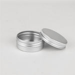 Wuiil metal tins displayed with screw cap lids removed.