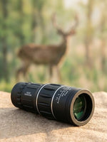 Waterproof and fogproof high power monocular telescope placed on a rocky outdoor hiking trail.