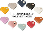 Heart shape cable organizer straps keeping charging cords organized inside a travel cosmetic bag