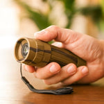Handheld view demonstrating compact size of the monocular.
