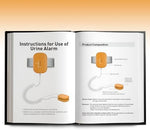 Bedwetting alarm kit including orange device and user manual.
