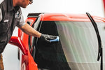 Nanodiamond window coating kit for cars displaying professional glass prep and sealant bottles.