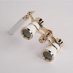 Marsrut white opera glasses shown alongside the included neck chain and cleaning cloth accessory kit