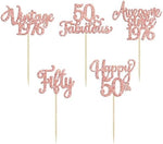 Group of elegant rose gold 50th birthday party supplies