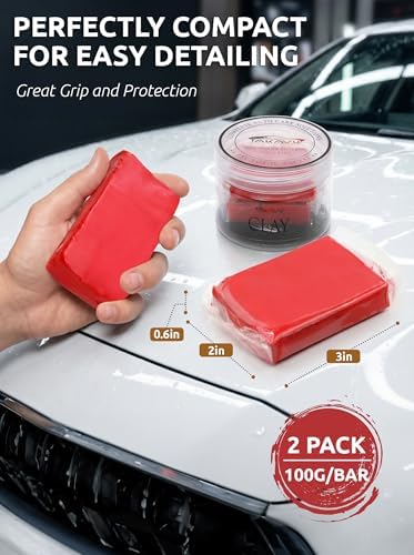 Two pieces of red TAKAVU premium medium grade auto detailing magic clay bar cleaner resting beside the packaging container