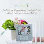 Tiny Ideas family sentiment photo frame styled as a tabletop decoration on a nursery shelf.