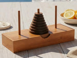 BSIRI Tower of Hanoi puzzle showing the wooden storage base box holding the nine rings and pegs securely.